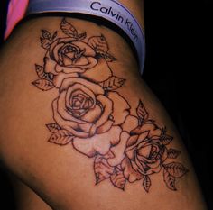 a woman's thigh with a rose tattoo on her leg and the word calm kleen written in black ink