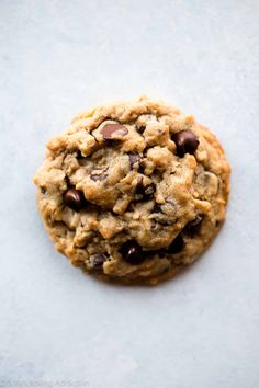 a chocolate chip cookie on a white surface