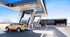 an orange car is parked in front of a gas station with its doors open and the roof opened