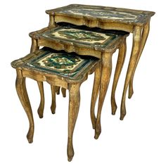 three wooden tables with mosaic designs on them