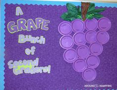 a bulletin board with purple grapes on it