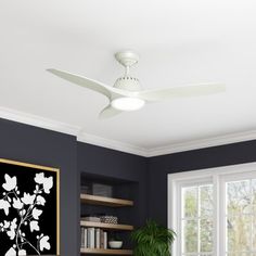 a living room with a couch, coffee table and ceiling fan in the middle of it