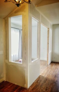 an empty room with hard wood flooring and white paint on the walls is shown