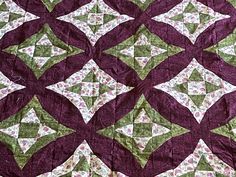 a close up of a quilt with many different designs on the top and bottom half