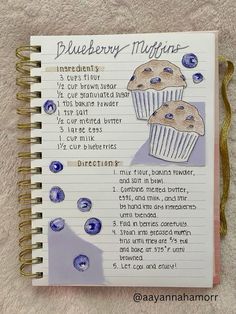 a recipe book with blueberry muffins written in cursive writing on it