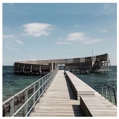 a wooden pier with stairs leading to the water