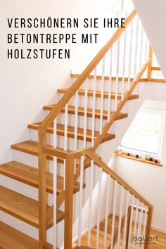 a wooden staircase with white handrails in a house