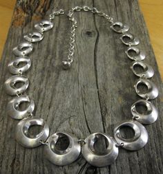 "DESCRIPTION: ca. 1960: This necklace is really great. It's a nice chunky weight of solid sterling silver, adjustable from 14.5 inches all the way up to 20 inches to accommodate different necklines and make different looks, and it has the high end design of graduated circles that represent the Mobius Strip.  And to top it all off, as a sweet surprise, the maker's mark charm by the clasp has a small but pretty prong set diamond on it!  Quality, quality, quality.  Perfect day or night.  You will l Retro Round Metal Necklaces, Retro Round Metal Necklace, Retro Round Necklaces For Formal Occasions, Retro Round Necklace For Formal Occasions, Retro Adjustable Silver Necklace, Mid-century Adjustable Silver Jewelry, Retro Silver Round Necklace, Vintage Metal Necklace With Polished Finish, Mid-century Silver Necklace Gift