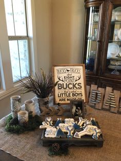 a table topped with lots of items and a sign that says buck's little boys