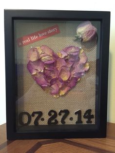 a frame with flowers in it and the date is on display for someone to see