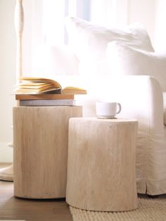 a coffee table with two books and a cup on it