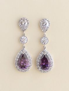 Luxury purple amethyst cubic zirconia bridal teardrop earrings in rhodium plated brass setting. I've created these luxurious earrings using a large teardrop with pear cut purple amethyst cubic zirconia center surrounded by tiny round zirconia crystals. Teardrop dangles from a clear cubic zirconia ear stud and a round cubic zirconia connector. Total length of the earring is 4.6 cms. For matching necklace click: https://www.etsy.com/listing/465785454/purple-amethyst-cubic-zirconia-bridal?ref=listi Purple Drop Earrings, Black Crystal Earrings, Teardrop Bridal Earrings, Pink Pearl Earrings, Lavender Earrings, Wedding Earrings Drop, Gold Bridal Earrings, Luxury Earrings, Zirconia Earrings