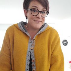 a woman wearing glasses and a yellow sweater