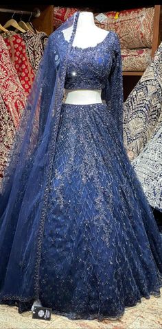 a blue lehenga on display in a store