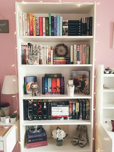 a white book shelf filled with lots of books