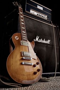 an electric guitar sitting next to a amp