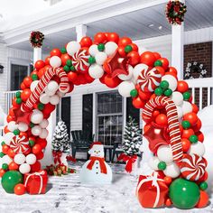 an outdoor christmas decoration with balloons and candy canes