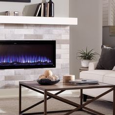 a living room with a couch, coffee table and fire place in front of the fireplace