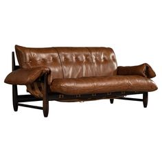 a brown leather couch sitting on top of a wooden frame