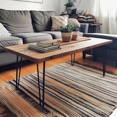 a living room with a couch, coffee table and rug