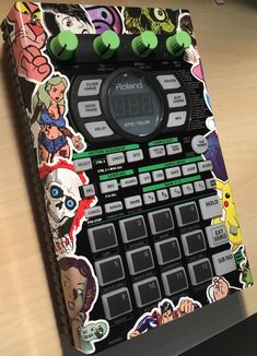 an old school calculator with stickers on it