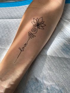 a woman's arm with a tattoo that reads, love and lotus on it