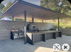 a large outdoor kitchen with an oven and grill