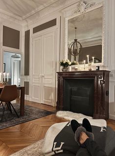 a person laying on the floor in front of a fireplace