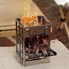 an open fire pit sitting on top of a table