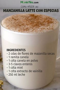 there is a cup of coffee with cinnamon on the top and spices in front of it