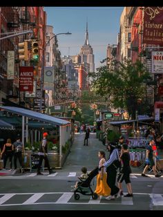 people crossing the street at an intersection in new york city