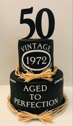 a 50th birthday cake with an aged to perfection sign on the top and 50 year old age