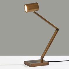 Modern functionality and industrial styling meet in the Newman Desk Lamp. This high end desk lamp has a metal finish and is adjustable at 3 points to direct light exactly where it is needed. A cylinder shade houses an integrated, eco-friendly 10W LED light that is replaceable. With a 4-way touch switch conveniently located on the base, this lamp offers a 3 levels of brightness (low, medium, high), making the perfect lighting available at the touch of a finger. 
For added functionality, the base of the lamp houses an integrated Qi-certified charging pad, supporting 5W charging on contact to get your phone from 0% to 100% in just 3-4 hours. A USB port is also located on the side of the base for charging a second device simultaneously. The lamp is powered by a 5 foot black fabric covered cord Shade House, Virtual Staging, Touch Switch, Charging Pad, Metal Lamp, Desk Design, Metal Finishes, Bronze Color, Brass Color