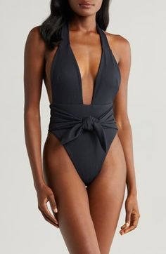 A plunging neckline fronts this sultry halter swimsuit tethered with a defining waist tie. Halter neck Ties at waist Lined 90% nylon, 10% spandex Hand wash, dry flat Made in the USA Chic Halter Neck Swimwear For Party, Elegant Halter Top For Beach Season Swimming, Elegant Halter Top For Beach Season, Elegant Black Halter Top For Poolside, Chic Halter Neck Swimwear With Lined Body, Chic Black Halter Neck Swimwear, Elegant Halter Neck Bodysuit For Beach Season, Chic Halter Neck Bodysuit For Pool, Chic Black Halter Top For Pool