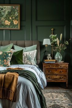 a bedroom with green walls and bedding, two lamps on either side of the bed