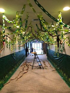 a room with green and white decorations hanging from the ceiling