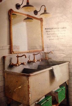 an old sink with two faucets and a mirror above it in a bathroom