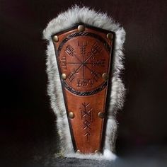 a leather shield with viking symbols on it