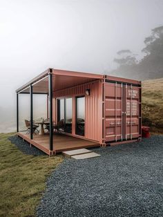 a shipping container sitting on top of a grass covered field