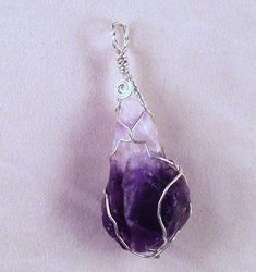 Custom made Sterling Silver wire wrapped Amethyst crystal hand crafted high in the mountains of Northern New Mexico by the artists at Alta Studios. Each piece is hand made - Item shipped may vary slighty from item shown in pictures. 8 oz. Shipping Weight * Necklace not included * Spiritual Wire Wrapped Crystal Pendant, Handmade Pendant Crystals For Jewelry Making, Spiritual Hand Wrapped Crystals For Jewelry Making, Wire Wrapped Crystals For Jewelry Making, Unique Amethyst Wire Wrapped Crystal Necklace, Handmade Amethyst Pendant Crystal, Bohemian Wire Wrapped Crystals For Healing, Bohemian Wire Wrapped Healing Crystals, Handmade Bohemian Purple Crystals