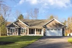 a large house with two garages in the front yard