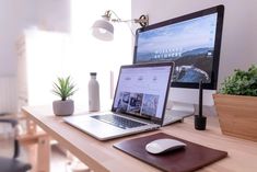 an open laptop computer sitting on top of a wooden desk