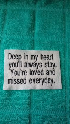 a towel with a poem written on it that says deep in my heart you'll always stay, you're loved and missed everyday