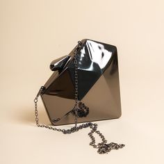 Black Geometric Triangle - Hexagonal Clutch - A Sleek and Modern Evening Accessory Elevate your formal attire with this stunning black clutch bag. Crafted with a sleek, geometric hexagonal shape, this black evening bag features a glossy, metallic material that exudes sophistication and elegance. Black Clutch Bags for Evening Designed to hold your essentials, including makeup, phone, cards, and cash, this black clutch is the perfect companion for weddings, proms, cocktail parties, and other speci Black Square Bags For Party, Black Square Clutch For Party, Elegant Evening Shoulder Bag With Geometric Shape, Modern Black Clutch For Events, Black Rectangular Wedding Bags, Black Square Evening Bag As Gift, Black Square Clutch For Formal Occasions, Modern Black Evening Bag For Night Out, Formal Black Square Clutch