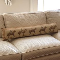 a couch that has some horses on it