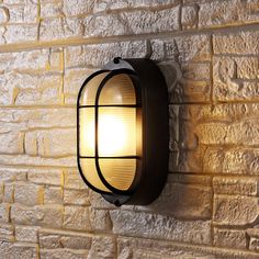 a light that is on the side of a brick wall