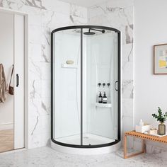 a corner shower in a white bathroom with marble walls and floor, along with a bench