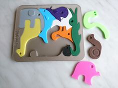 several different shapes and sizes of magnets on a counter top, with one elephant in the middle