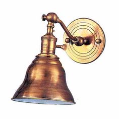 an antique brass wall light with a white background