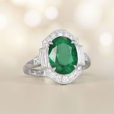 This item has just been reserved by another customer. Please contact us to be notified if it becomes available.  This stunning ring showcases a magnificent oval-cut emerald weighing approx 3.71 carats as its center, delicately held in place by prongs. The emerald is beautifully encircled by a halo of diamonds. On either side of the center stone and along the ring's shoulders, baguette-cut diamonds are accented. The total diamond weight of this ring is approximately 0.60 carats. The platinum sett Estate Diamond Jewelry, Smaragd Ring, Oval Cut Engagement Ring, Baguette Cut Diamond, Platinum Ring, Oval Diamond, Oval Cut, Emerald Ring, Amethyst Ring